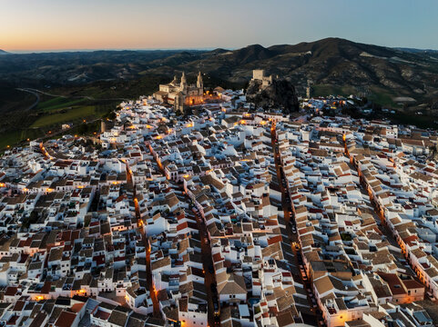 Aerial view of beautiful historic architecture and quaint white buildings with a scenic backdrop of mountains, Olvera, Cadiz, Spain.