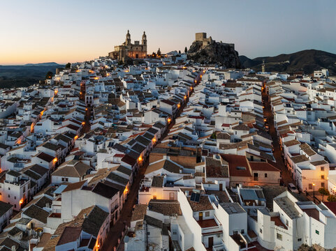 Aerial view of the historic old town with beautiful whitewashed buildings and rooftops at dusk, Olvera, Cadiz, Spain.