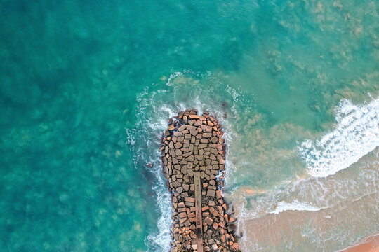 Aerial view of beautiful cliff beach with rocks and turquoise ocean, Algave, Portugal.