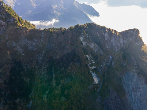 Aerial view of majestic mountains under a serene sky with picturesque clouds, Stoos, Schwyz, Switzerland.