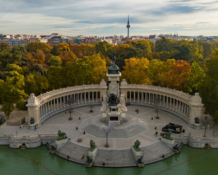 Aerial view of parque el retiro with monumento a alfonso xii surrounded by trees and water, Retiro, Madrid, Spain.