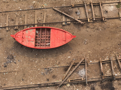 Aerial view of a dockyard with ships and a red boat on wooden tracks, Dhaka, Dhaka, Bangladesh.