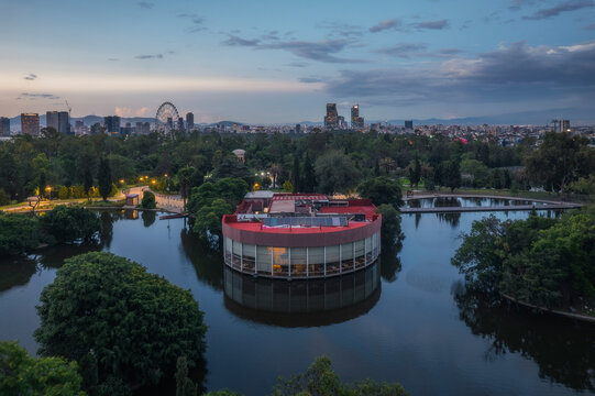 Aerial view of Chapultepec Lake surrounded by urban architecture and greenery at dusk, Miguel Hidalgo, Mexico City, Mexico.