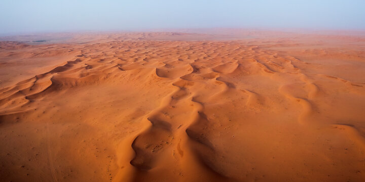 Aerial view of vast sand dunes in a serene desert landscape, Al Zulfi governorate, Riyadh, Saudi Arabia.