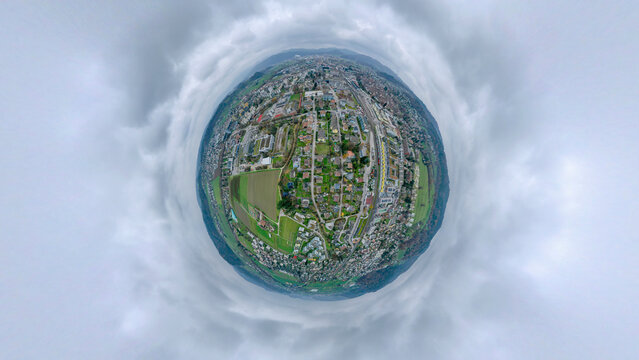Aerial view of a tiny planet perspective of Zofingen city with beautiful clouds and scenic countryside, Aargau, Switzerland.