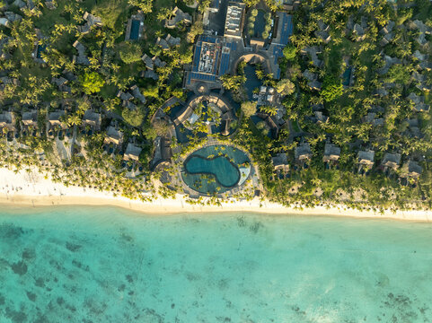 Aerial view of the beautiful tropical beach with luxury resort and clear blue water, Trou aux Biches, Pamplemousses, Mauritius.