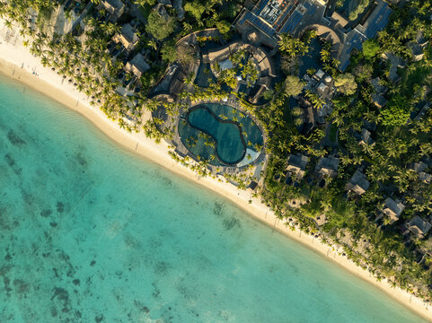 Aerial view of beautiful tropical beach with clear blue water and palm trees, Trou aux Biches, Pamplemousses, Mauritius.