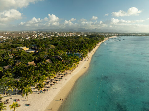 Aerial view of tranquil tropical beach with azure ocean and palm trees, Trou aux Biches, Pamplemousses, Mauritius.