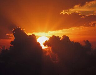 Fototapeta premium A dramatic sunset with a partially obscured sun casting an orange glow through billowing clouds against a darkening sky