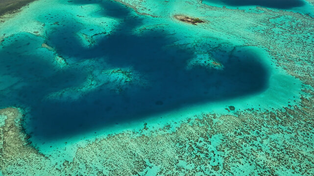 Aerial view of a beautiful tropical island with a pristine reef and clear turquoise ocean, Eastern, Fiji.