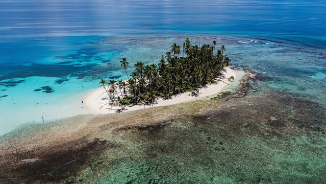 Aerial view of beautiful San Blas Island with turquoise water, palm trees, and sandy beach, Kuna Yala, Panama.