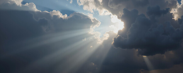 The sun's rays break through the fluffy clouds