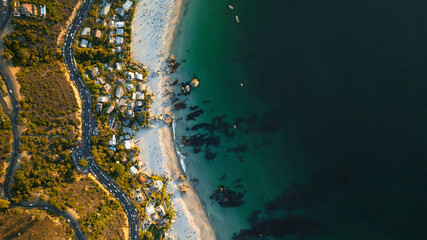 Aerial view of abstract coastal ocean with beautiful beach and residential homes, Clifton, Western Cape, South Africa.