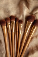 Elegant makeup brushes arranged on soft fabric, showcasing their