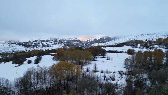 Aerial view of serene snowy landscape with majestic mountains and tranquil forest, Posof, Ardahan, Turkiye.