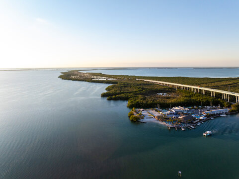 Aerial view of tranquil Blackwater Sound and Florida Bay with a scenic bridge and lush island, Jewfish, Key Largo, Florida, United States.