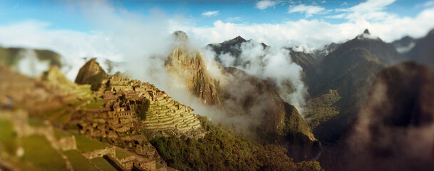 Panoramic view of ruins of buildings at an archaeological site, Inca Ruins, Machu Picchu, Cusco Region, Peru.