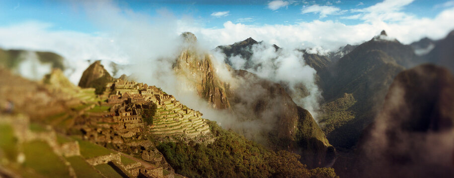 Panoramic view of ruins of buildings at an archaeological site, Inca Ruins, Machu Picchu, Cusco Region, Peru.