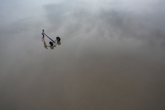 Aerial view of serene water reflecting clouds with a tranquil silhouette, Teknaf, Chattogram, Bangladesh.