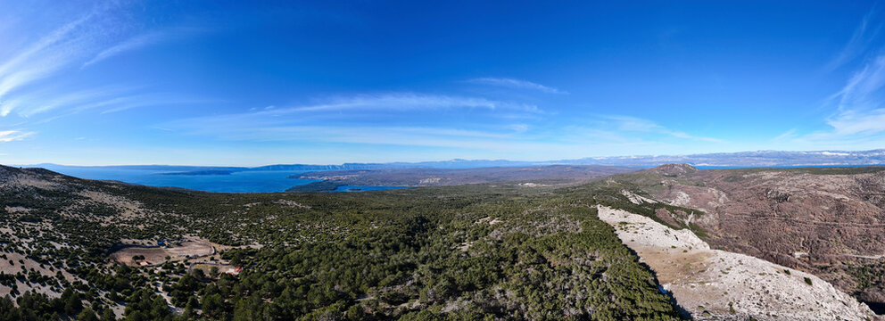 Aerial view of beautiful forest panorama with majestic mountains and clear sky, Baska, Primorje-Gorski Kotar, Croatia.