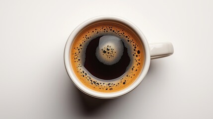 Close-up of a steaming cup of black coffee with frothy crema on the surface.