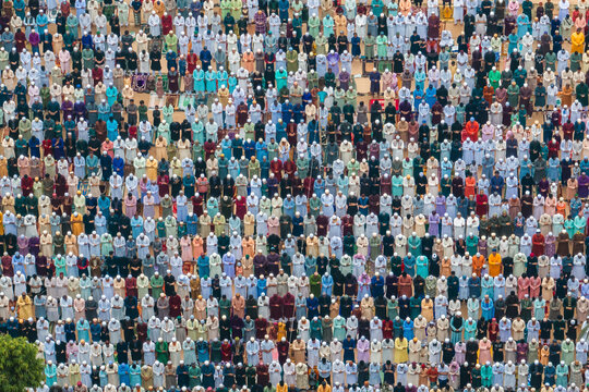 Bogura, Bangladesh - 11 April 2024: Aerial view of a large crowd gathered for Eid Prayer in a colorful and organized assembly, Bogura, Rajshahi, Bangladesh.