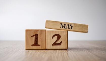 Minimalist photo of wooden blocks with date 12 May. Day and month, calendar on white background