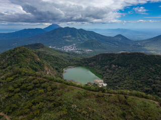 Aerial drone panorama of Laguna de Alegria - small lake with green water surrounded by lush green...