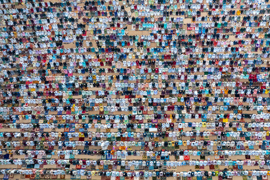 Aerial view of a colorful and diverse eid prayer gathering with a large crowd of devotees, Bogura, Rajshahi, Bangladesh.