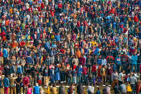 Shibganj, Bangladesh - 19 February 2022: Aerial view of a vibrant and bustling majlis public food offering with a large gathering of diverse people celebrating together, Saidpur, Shibganj, Rajshahi, B