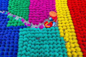 Aerial view of vibrant workers engaged in traditional drinking straw making with colorful patterns, Porsha, Naogaon, Rajshahi, Bangladesh.
