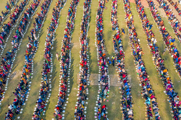 Aerial view of a vibrant majlis public food offering with a colorful crowd and organized patterns, Saidpur, Rajshahi, Bangladesh.