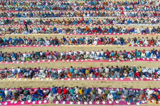 Bogura, Bangladesh - 12 February 2021: Aerial view of a vibrant gathering of people participating in a majlis public food offering during Ramadan, Sekherkola, Bogura, Rajshahi, Bangladesh.
