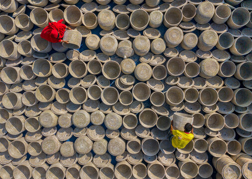 Bogura, Bangladesh - 29 October 2020: Aerial view of artisans making traditional handicrafts with baskets and pottery, Sherpur, Rajshahi, Bangladesh.