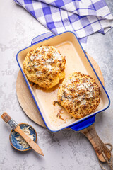 Whole baked cauliflower with truffle butter in a casserole