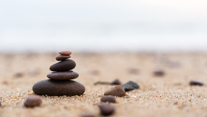 Rock stone stack balance pyramid on sand beach seaside, Symbol Sign of Zen with nature meditation...