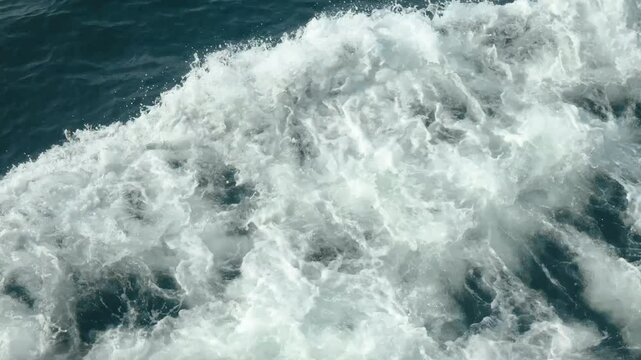 Dynamic movement of ocean waves background. Deep blue sea with white foam. Tranquility of water. Fast move on ship, jet ski or motor boat. Foamy trace. Speed motorboat.