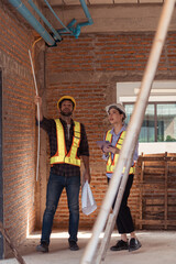 Architects and engineers work together to assess the residential home construction site's progress