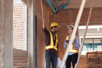 Architects and engineers work together to assess the residential home construction site's progress