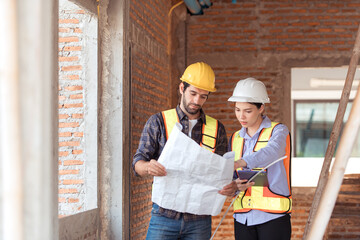Architects and engineers work together to assess the residential home construction site's progress