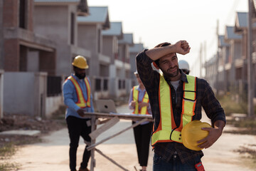 Portrait of engineers work together to assess the residential home construction site's progress
