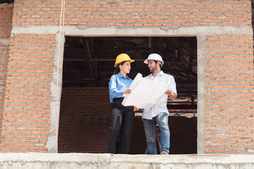 Architects and engineers work together to assess the residential home construction site's progress