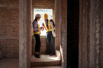 Fototapeta premium Architects and engineers work together to assess the residential home construction site's progress