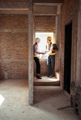 Architects and engineers work together to assess the residential home construction site's progress