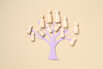 Family tree made with wooden pieces on beige background, top view