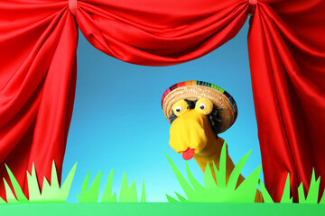Creative puppet show on stage with decorations and red curtains