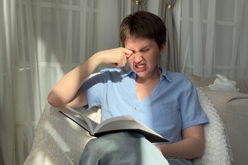 young woman holding glasses rubbing eyes, feels tired. suffering from ocular diseases, eye strain.