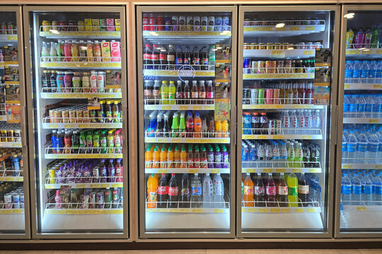 Penang, Malaysia - Mar 26, 2025: Wide-angle view of a refrigerated beverage display inside a Shell petrol station, showcasing a colorful assortment of bottled drinks.