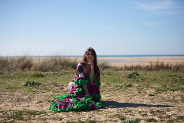 Latin woman, brunette, with flowing hair, dancing flamenco in a white dress with floral print and...