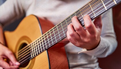 Fototapeta premium Fingers playing a guitar strings